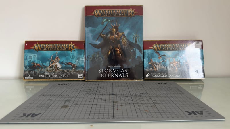 The day's haul laid out: a Knight-Judicator with Gryph-hounds box, the Stormcast Eternals battletome and a box of Vanguard-Raptors.